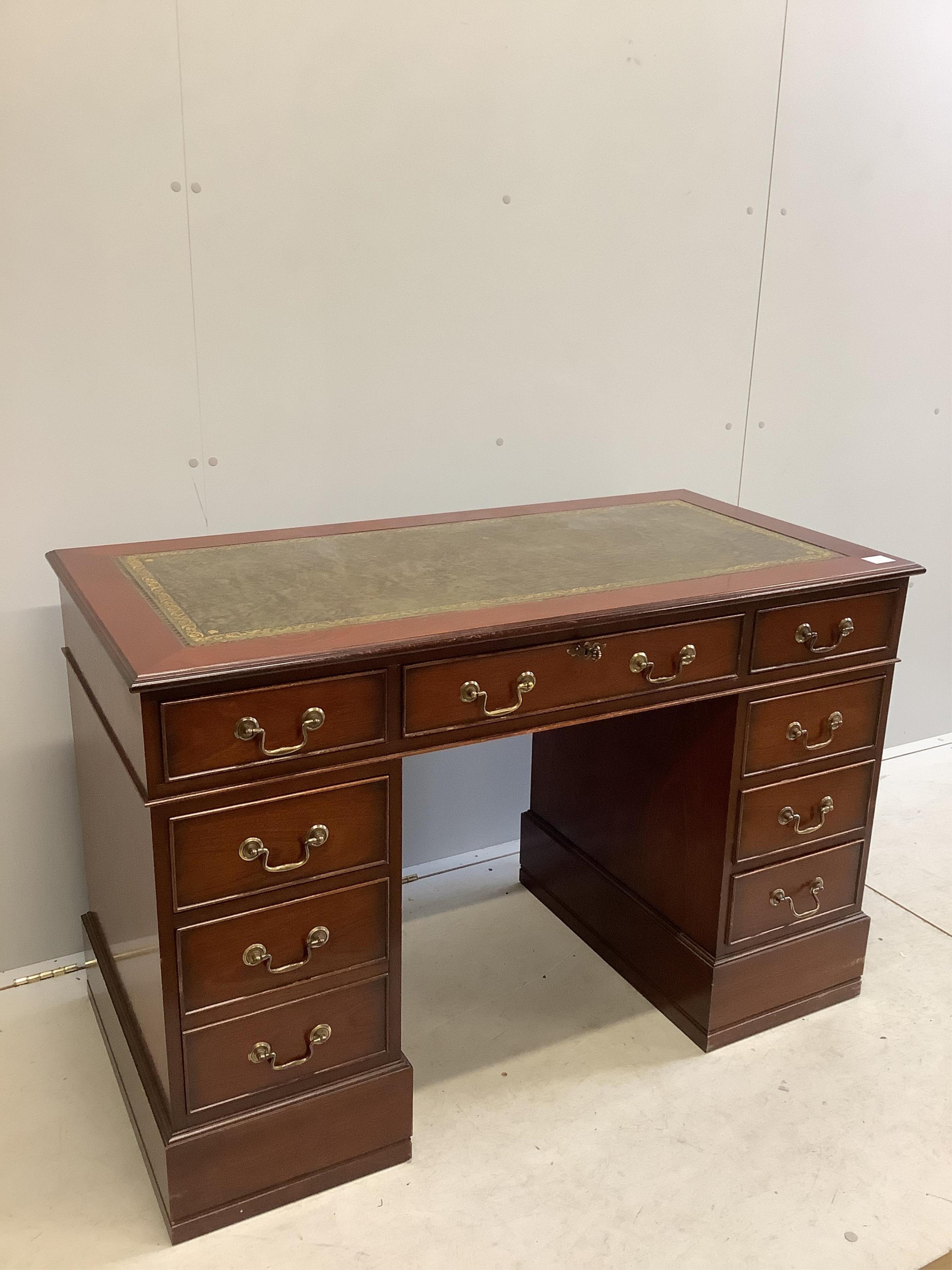 A George III style mahogany pedestal desk, fitted with nine small drawers, width 121cm, depth 60cm, height 79cm. Condition - fair to good